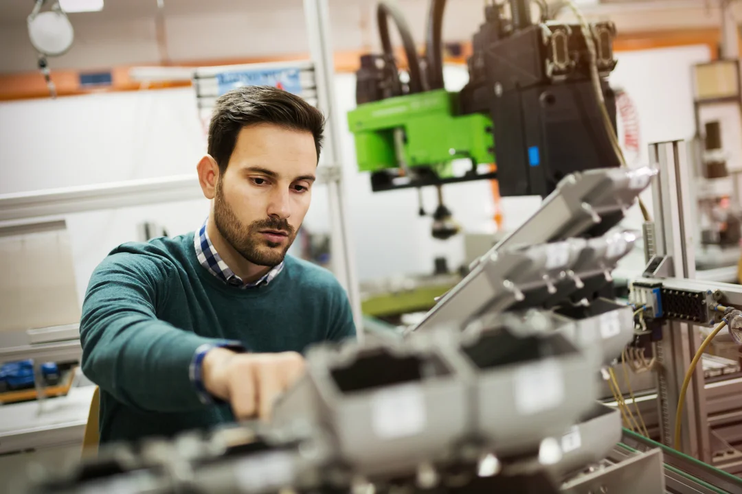 man-inspecting-robotic-manufacturing-machine-eurocruitment